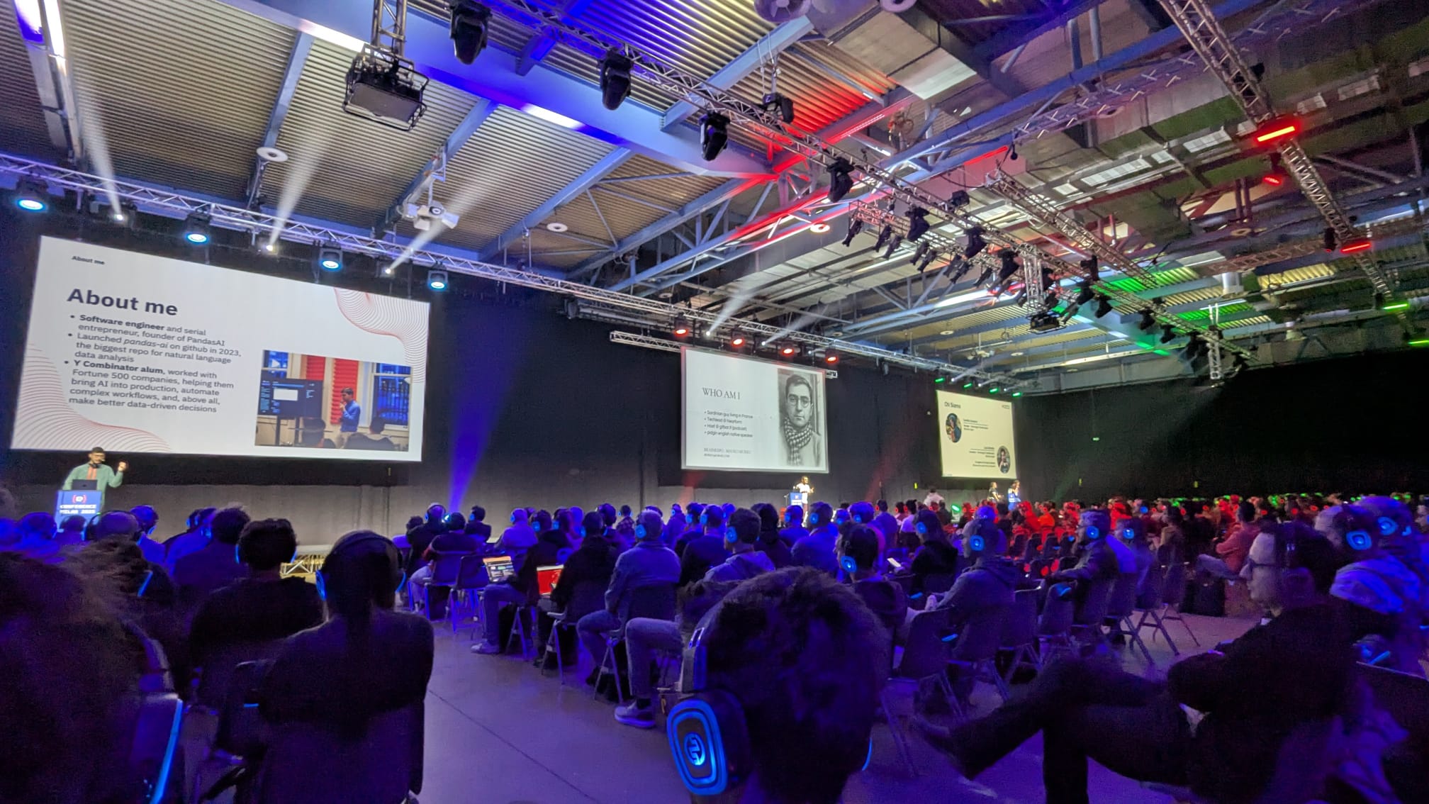 Three of the multiple stages of Codemotion Milan 2025 with the respective speakers presenting to the audience